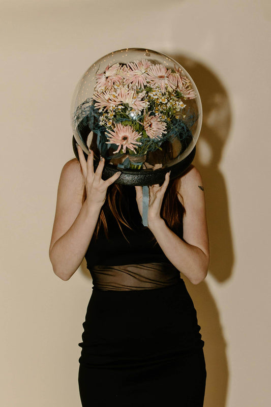 Woman hidden behind flowers, illustrating the future of beauty and regenerative medicine