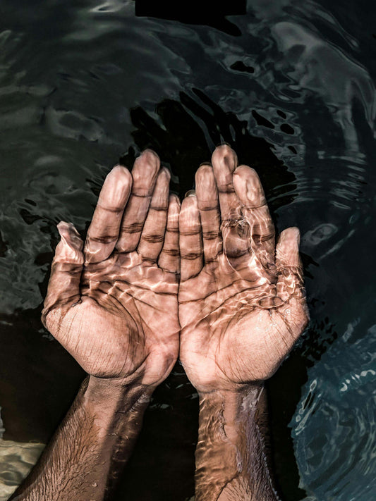 Cupped hands in water – symbolising cellular renewal and NAD+ regenerative therapy
