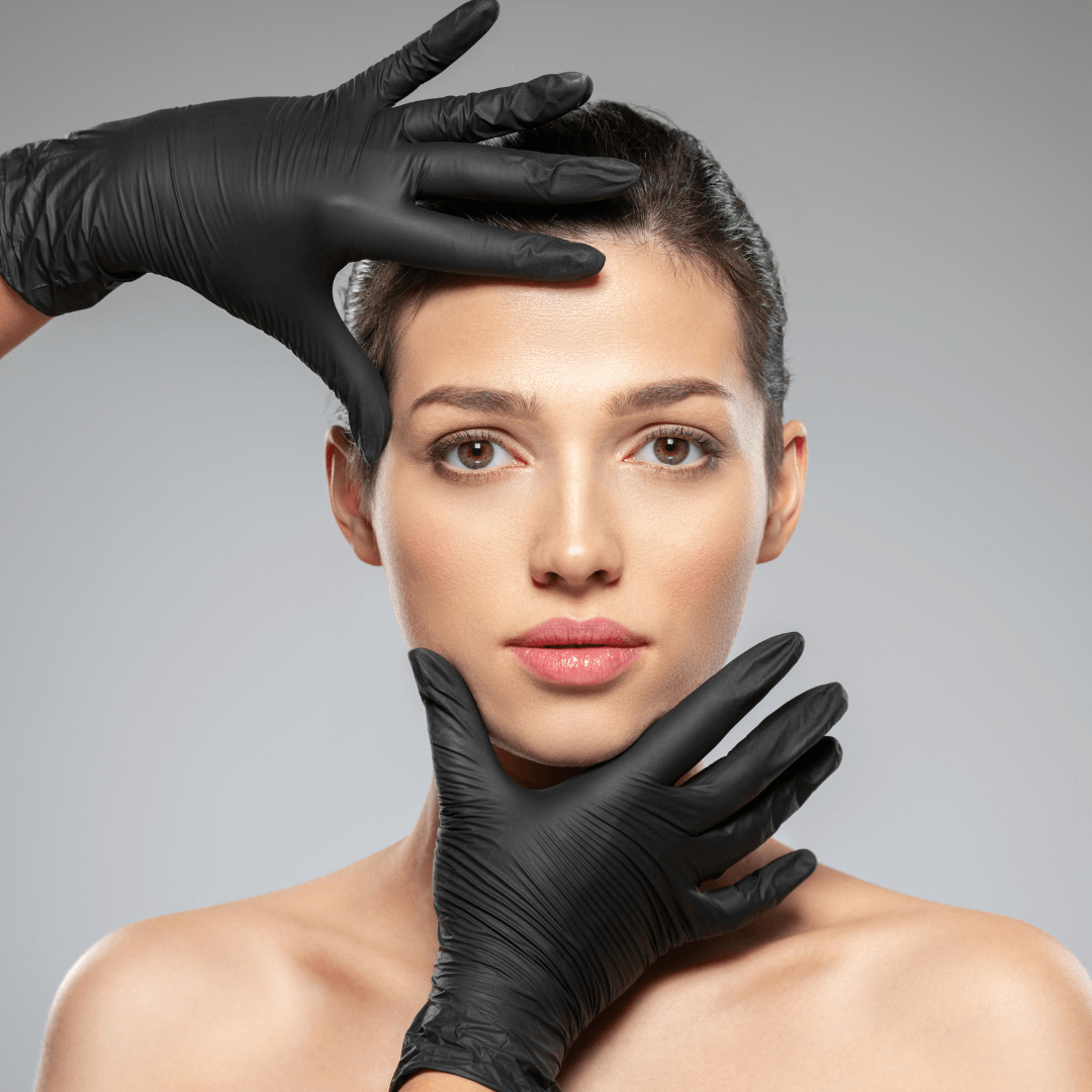 Gloved hands framing a woman’s glowing skin after exosome aesthetic therapy.