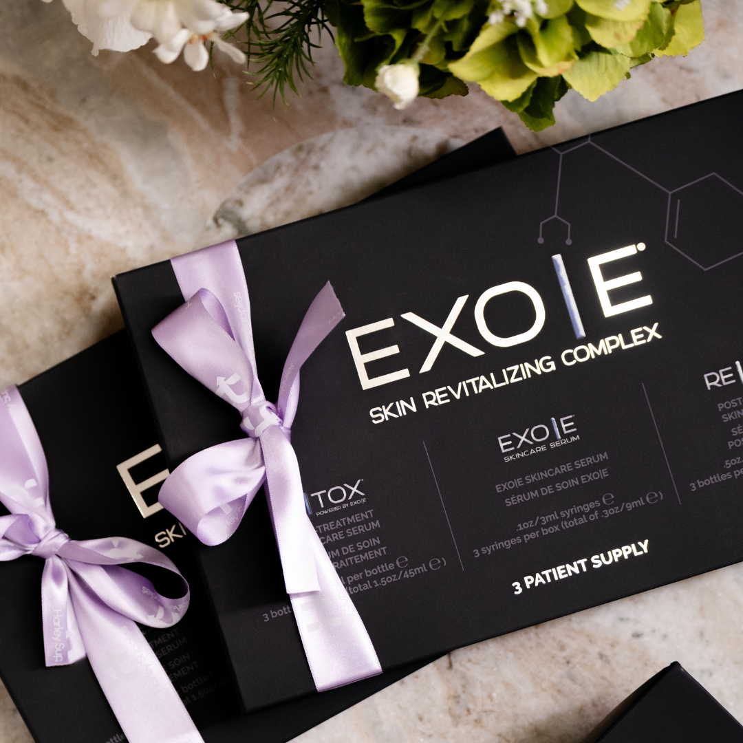 EXOIE Skin Revitalizing Complex packaging with a purple Harley Supplies ribbon on a marble surface.