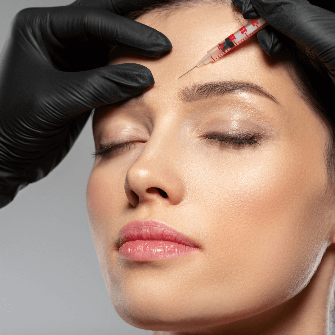 Clinician performing skinbooster injection near woman’s forehead – aesthetic treatment