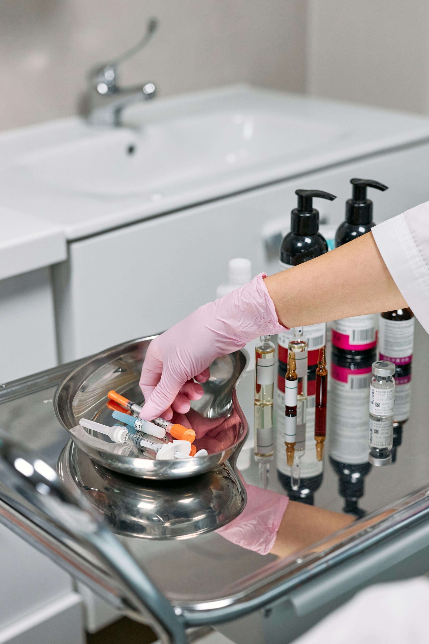 Hand reaching for items on a fully stocked medical cart – clinical essentials and consumables
