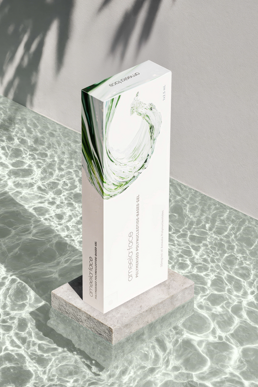 Tall, rectangular Ameela Face box on a textured surface with a blurred background