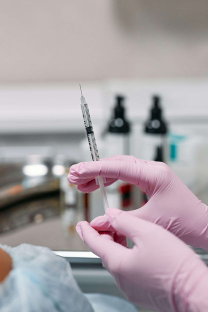 Gloved hands holding syringes from new injector starter kit – essential tools for aesthetic beginners